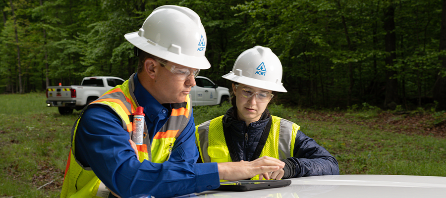Utility forestry professionals reviewing field data as part of safety management systems that support risk reduction and safe work practices.